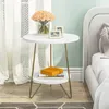 A round side table with two shelves next to a bed. Anteprima dell’immagine prodotto