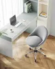 A gray office chair next to a desk with a laptop and a cup of coffee. Voir les images du produit