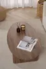 A coffee table with a candle and magazines on it, placed on a rug in a living room setting. Anteprima dell’immagine prodotto