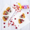 Heart-shaped waffles decorated with chocolate, white icing, and ladybug sprinkles, scattered with red heart sprinkles. Anteprima dell’immagine prodotto