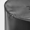 A close-up view of the top of a black cylindrical object, showing a zipper closure with two pulls. The surface appears wet or shiny. Náhled obrázku produktu