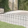 A garden scene with a fence in the foreground, a paved area, and greenery in the background. Anteprima dell’immagine prodotto