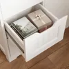 An open drawer of a white cabinet, showing books and gift boxes inside. Náhled obrázku produktu
