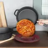 A cast iron pot and pan are shown with a pizza on a plate. Náhled obrázku produktu
