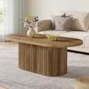 A living room scene with a coffee table, sofa, and rug. Voir les images du produit