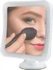 A woman applying makeup using a makeup mirror. Produktbild-Vorschau