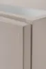 A close-up view of the corner of a beige cabinet. Produktbild-Vorschau