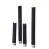 Four black LED taper candles of varying heights are arranged in a line against a white background. Produktbild-Vorschau