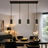 A dining room with a table and chairs, illuminated by a pendant light fixture. Podgląd zdjęcia produktu