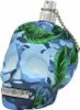 A perfume bottle shaped like a skull with a camouflage and jungle leaf design. Podgląd zdjęcia produktu