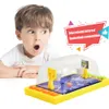 A young boy looking with surprise at a desktop basketball game. Produktbild-Vorschau