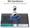 A screen protector is shown on top of a phone screen, with two metal balls demonstrating its hardness. Produktbild-Vorschau