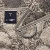 A close-up view of a gray towel with a Joop! logo tag and a hanging loop. Produktbild-Vorschau