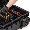A gloved hand is shown reaching into a black tool box, organizing tools. Náhled obrázku produktu