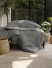 A bedroom scene with bedding and plants. Produktbild-Vorschau