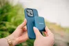 A person is holding a blue iPhone with a blue Verbatim SSD attached to the back. Náhľad obrázku produktu