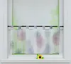 A short curtain with a colorful firework pattern hangs on a window rod. A single sunflower rests on the windowsill below. Produktbild-Vorschau