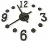 A close-up shot of a modern, minimalist wall clock with black numbers and hands on a white background. Náhled obrázku produktu