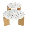 A set of two round nesting tables with terrazzo-style tops and wooden legs, presented against a white background. Voir les images du produit