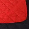 A close-up view of a quilted red blanket folded over a black quilted surface. Náhľad obrázku produktu