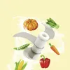 A food processor blade with various vegetables arranged around it. Náhľad obrázku produktu
