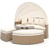 A beige and brown outdoor lounge set with a canopy, including a sofa, two ottomans, and a small table. Voir les images du produit