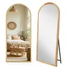 A full-length arched mirror with a gold frame, shown in two views: one reflecting a bedroom scene and the other standing alone. Voir les images du produit
