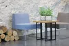 Two chairs and a small table with plants in front of a stone wall, with logs on the left. Náhľad obrázku produktu