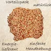A pile of birdseed with German marketing text overlayed. Produktbild-Vorschau