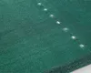 A close-up, angled view of a dark green shade net with small, evenly spaced holes. Produktbild-Vorschau