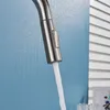 A close-up shot of a kitchen faucet with water flowing out. Produktbild-Vorschau