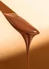 A close-up of chocolate cream being drizzled from a spatula. Produktbild-Vorschau