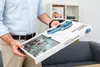 A person is holding a Porsche 911 Advent Calendar box in front of a shelf. Náhľad obrázku produktu