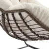 A close-up view of the underside of a rattan chair with a beige corduroy cushion. Anteprima dell’immagine prodotto