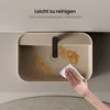 A hand is cleaning a beige sink with a white cloth. The sink has some brown stains. Voir les images du produit
