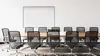 A meeting room with a whiteboard and chairs around a table. Produktbild-Vorschau