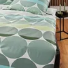 A close-up view of bedding with a circular pattern. Produktbild-Vorschau