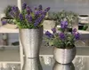 Two artificial lavender plants in silver textured pots are displayed on a reflective surface, likely a shelf or table. Produktbild-Vorschau