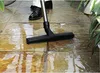 A person is vacuuming a wet patio with a Nilfisk Attix vacuum cleaner. Podgląd zdjęcia produktu