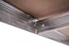 Close-up view of metal ceiling grid system with brown panels. Náhled obrázku produktu