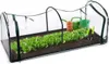 A small greenhouse with rows of lettuce growing inside, along with gardening tools and watering cans. Produktbild-Vorschau