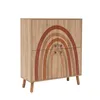 A wooden cabinet with a rainbow design on the doors, standing on four legs. Náhled obrázku produktu