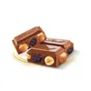 Two pieces of chocolate with nuts and raisins on a white background. Podgląd zdjęcia produktu