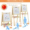 Three wooden easels of different heights are displayed, with magnetic drawings on the whiteboards and accessories on the trays. Silhouettes of children are shown next to the easels to indicate height. Produktbild-Vorschau