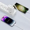 A white multi-port charger is plugged into a power strip and is charging two smartphones. Produktbild-Vorschau