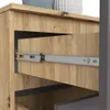 A close-up view of a drawer slide mechanism on a wooden dresser. Produktbild-Vorschau
