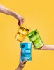 Three hands holding different types of konjac diet food products against a yellow background. Produktbild-Vorschau