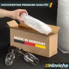 A hand is placing bubble wrap into a cardboard box labeled "MADE IN GERMANY" next to two wine glasses. Produktbild-Vorschau