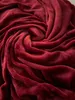 A close-up, swirling texture of a red blanket. Produktbild-Vorschau