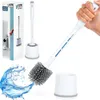 A toilet brush and holder set is displayed with a splash of water, suggesting its use. The product packaging is also visible in the background. Podgląd zdjęcia produktu